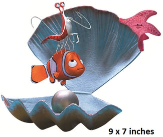 Decorative wall art of a clam with a clownfish and starfish inside, on a white background.