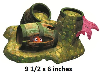 Decorative turtle shell with a small fish inside, surrounded by green and brown elements.