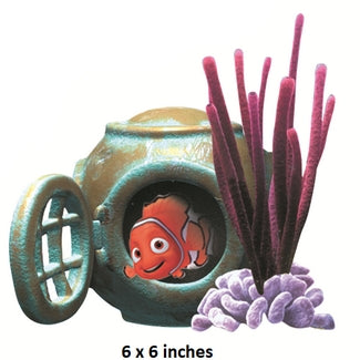 Decorative item with a fish inside a pipe and purple coral on a white background